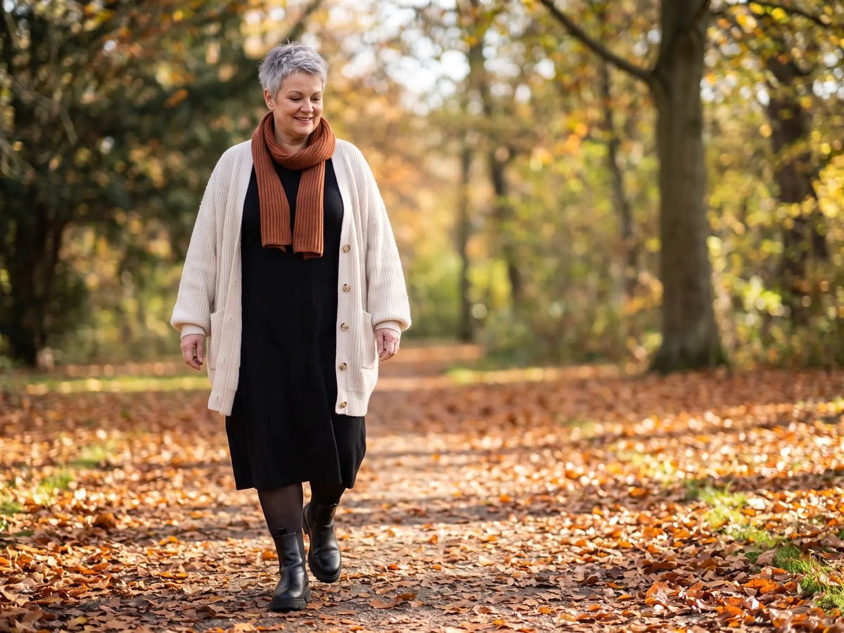 Frau mit Kurven im Lagenlook mit Cardigan, Midikleid und blickdichter Strumpfhose im Herbst